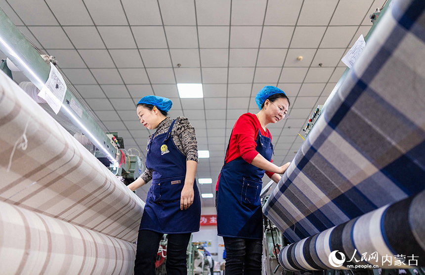 內(nèi)蒙古呼和浩特市玉泉區(qū)裕隆產(chǎn)業(yè)園精卓羊絨制品有限公司的生產(chǎn)車(chē)間內(nèi)，工人在生產(chǎn)線(xiàn)上趕制羊絨制品訂單。丁根厚攝